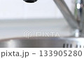 Water flows from a faucet to the sink. Opening and closing the tap. Air bubbles. In slow motion. 133905280