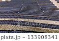 Unending lines of solar panels at a vast solar power plant. A bird's eye view of a solar field producing sustainable energy 133908341