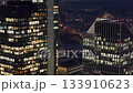 Aerial view of modern skyscrapers in Frankfurt financial district at night. Illuminated office windows revealing people working late 133910623
