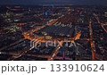 Nighttime aerial view of illuminated Frankfurt Central Station, Hauptbahnhof, with city's financial district surrounding the building 133910624