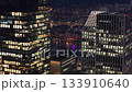 Aerial perspective of illuminated office building windows in Frankfurt financial district, bank and finance employees work at late night 133910640