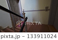Residential interior scene, person walking upstairs, unlocking entrance, entering living space of a modern design apartment in a typical European city, Berlin, 5.8.2025 133911024