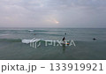 A man on a surfboard catches a wave in the sea. Drone Shooting 133919921