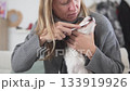 Beautiful woman brushing her teeth of a black and white dog of the Kings Charles Spaniel breed 133919926