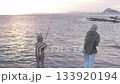 Children fishing with fishing rods by the sea at sunset. Spain 133920194