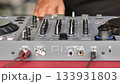 DJ playing music, mixing tracks on a turntable console at a party event 133931803
