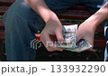 unrecognizable person outdoor counting one hundred dollar bills. closeup. 133932290