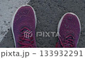 dirty purple sneakers standing on an urban street pavement. closeup. 133932291