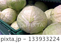 Green cabbages arranged in crates, emphasizing their fresh textures and vibrant colors, camera zooms in to capture the details and quality of the produce 133933224