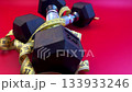 Dumbbells positioned on a striking red surface, wrapped with a measuring tape, emphasizing fitness and health, camera zooms in to capture intricate features 133933246