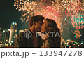 Young couple sharing a romantic moment under a vibrant firework display in a cityscape, celebrating love and connection amidst the festive atmosphere 133947278