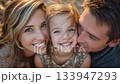 Loving parents showering affection on daughter, capturing tender moment of familial warmth and emotional connection in heartwarming close up portrait 133947293