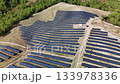 Drone perspective of a solar power plant on a rural hillside. Panels generating clean, renewable energy for a sustainable green future 133978336