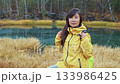 Asian hiker woman enjoying autumn forest scenery 133986425