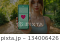 Healthcare scene where you check your heart rate app on your smartphone outdoors 134006426