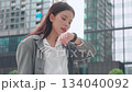 Young asian businesswoman using voice recording or speech recognition technology in smartwatch. 134040092