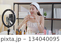 Young asian woman presenting and review cosmetic product with excitement on social media. 134040095