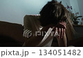 Young man lowering head onto arms feeling emotional exhaustion and sadness. Person leaning forward showing quiet despair and growing inner tension. Teenager resting head on hands reflecting deep 134051482
