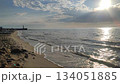 Seascape on sunny summer day. Sea waves rolling on sand of sandy beach on seashore. Waves of windless calm sea, blue sky with clouds and horizon line. Nature backdrop. Natural background 134051885