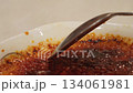Spoon taps the caramelized crust of creme brulee and scoops custard appetizing texture crunch and sugar shine versatile food shot for menus food blogs ads restaurants and recipes 134061981