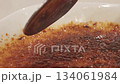 Spoon taps the caramelized crust of creme brulee and scoops custard appetizing texture crunch and sugar shine versatile food shot for menus food blogs ads restaurants and recipes 134061984