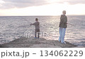 Boys fishing at sunset by the sea 134062229