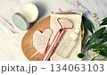 Rose quartz gua sha tool and oil bottle and face massage roller, beauty abstract photo. Top view 134063103