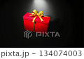Zoom-in view of vibrant red gift box with golden ribbon on black background. Festive animation for luxury and Christmas themes, holiday promotions, special offers, and advertising 134074003