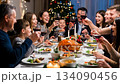 A large friendly family celebrates Christmas at the festive table. 134090456