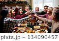 A large friendly family celebrates Christmas at the festive table. 134090457