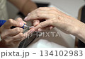 Guide to Classic French Manicure for Mature Hands With Modern Tools. Nail treatment with milling cutter 134102983