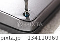 close up. screwdriver and screw. A technician disassembles a laptop. 134110969