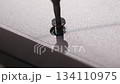 close up. screwdriver and screw. A technician disassembles a laptop. 134110975