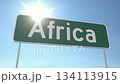 Green Road Sign With Word Africa Against Blue Sky and Bright Sunlight 134113915