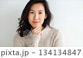A beautiful Korean woman in her thirties, wearing a sweater_1 134134847