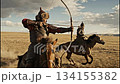 Watch skilled archers draw their bows while riding horses in slow motion. This event takes place in wide grasslands, showcasing traditional Mongol techniques and movements. 134155382