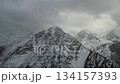 Majestic mountain range with snow-covered peaks, camera pans across landscape 134157393