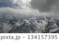 Snowy mountain landscape with dramatic clouds, camera pans across scene 134157395