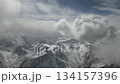 Snowy mountain landscape with dynamic cloud movement, camera pans across scene 134157396