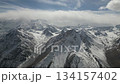 Snow-capped mountain range panorama with dynamic aerial camera movement 134157402