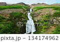 Scenic Mountain Waterfall Flowing Through Rocky Green Landscape 134174962