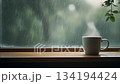 A rainy season cafe scene with steaming coffee on a rainy window (loop video) 134194424