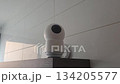 Rotating security camera captures room environment in smart home setup. Security camera - privacy mode turns on and hides the lens 134205577