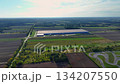 Birds-eye view of a modern logistics center with vast warehouses 134207550