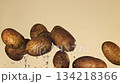 Potatoes fly up and fall on a light background. Filmed on a high-speed camera at 1000 fps. High quality FullHD footage 134218366