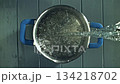 Water is poured into a saucepan. View from above. Filmed on a high-speed camera at 1000 fps. High quality FullHD footage 134218702