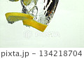 Lemon slices falling under water on a white background. Filmed on a high-speed camera at 1000 fps. High quality FullHD footage 134218704