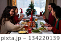 A large friendly family celebrates Christmas at the festive table. 134220139