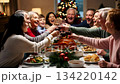 A large friendly family celebrates Christmas at the festive table. 134220142