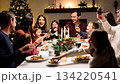 A large friendly family celebrates Christmas at the festive table. 134220541